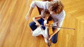 A boy gets violin lessons